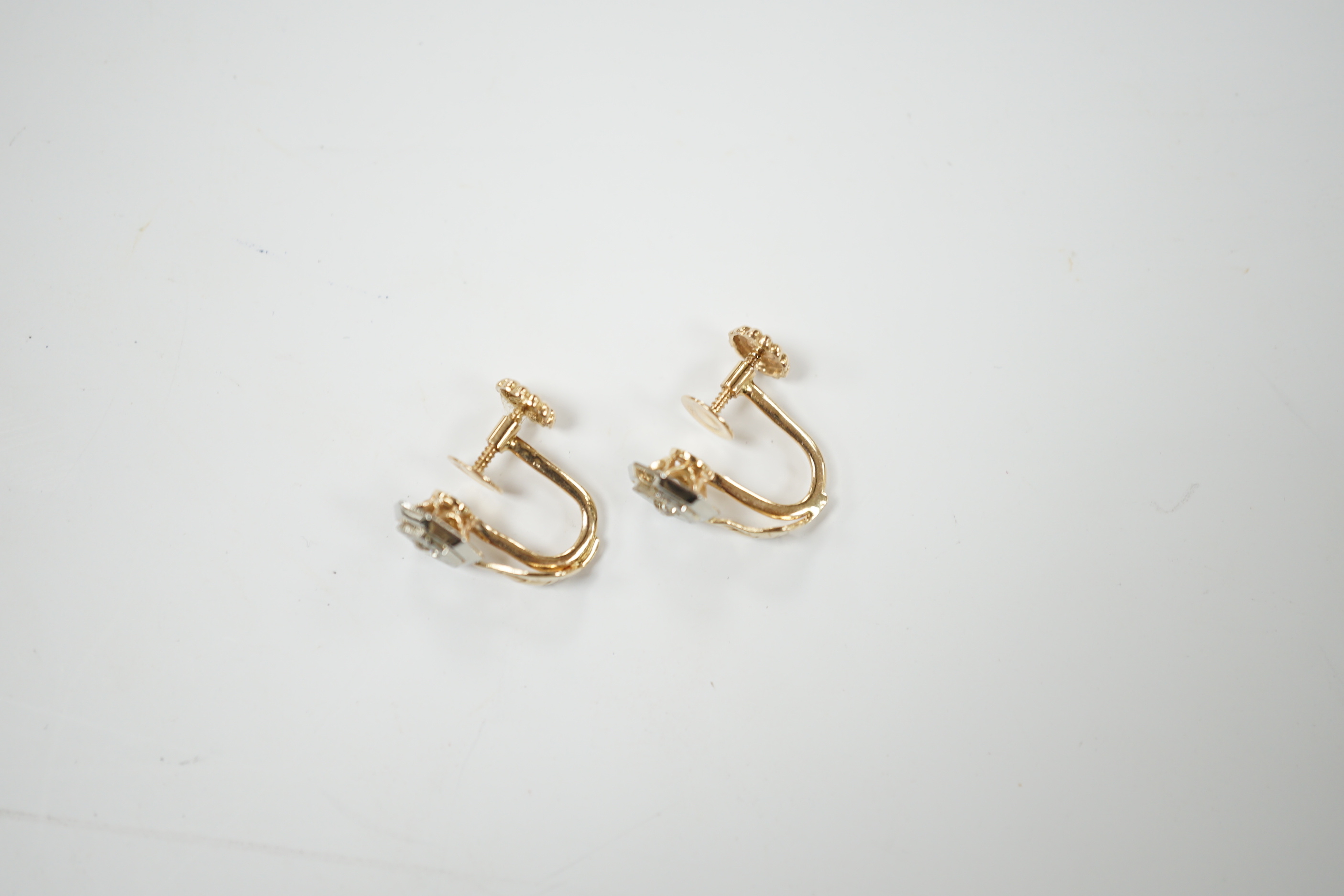 A pair of 14k gold and brilliant cut diamond earrings